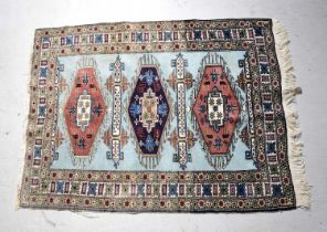 A hand knotted blue ground rug with geometric patterns, 163 x 118cm