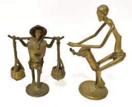 An African polished brass abstract figure of a drummer, height 29cm, and a smaller figure of a water