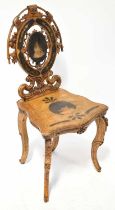 A Victorian walnut hall chair with pierced and pokerwork design, height 97cm (af). Condition Report: