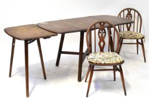 ERCOL; a dark elm drop-leaf dining table with one extra leaf, 72 x 74 x 135cm when extended, and