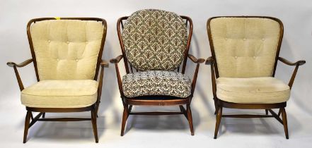 ERCOL; three dark elm stick back open armchairs on turned tapering legs (3).