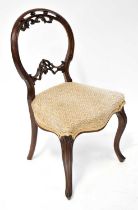 A Victorian rosewood balloon back side chair with scrolling decoration, serpentine front stuff-