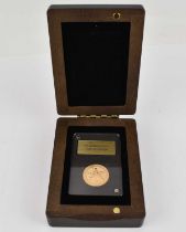 An Elizabeth II '95 Golden Years' sovereign, 2021, in presentation slab and wooden box, with