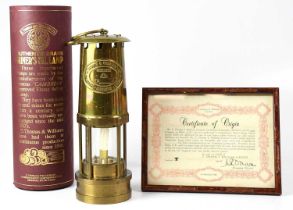 E. THOMAS WILLIAMS LTD; a brass cased miner's flame safety lamp with embossed panel, no. 163734