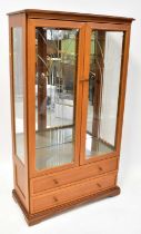 LEGATE; a modern glazed display cabinet with three glass shelves over two drawers, 150 x 85 x 40cm.