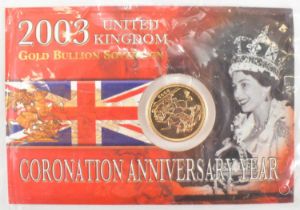 An Elizabeth II 2003 United Kingdom Coronation Anniversary Year sovereign, in cardboard blister pack