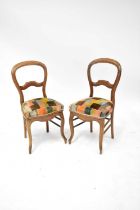 A pair of late Victorian mahogany balloon back dining chairs upholstered in a brown and green