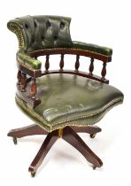 A reproduction green leather button back desk chair with swivel and tilt movement, on five splayed
