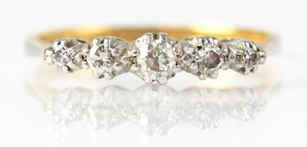 A 15ct yellow gold ring set with five graduated rose cut diamonds in a platinum claw setting,