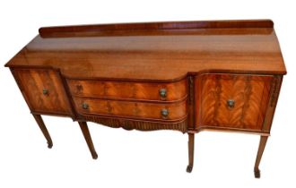 A Georgian-style mahogany breakfront sideboard with two drawers and a pair of cupboard doors, on