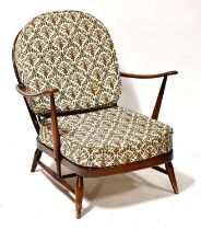 ERCOL; a dark elm stick back armchair with splat back, on turned tapering legs.