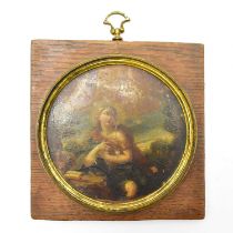 UNATTRIBUTED; a 19th century oil on copper circular miniature, lady holding a baby, in rural