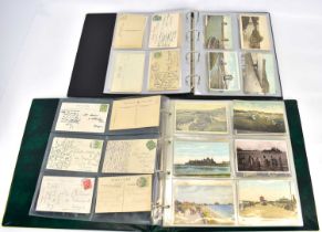 Two albums of black and white and colour used and unused postcards, mainly bridges and UK piers,