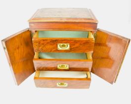 A mahogany table-top chest of three drawers with brass flush fitting handles, with double panelled