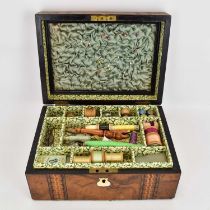 A 19th century walnut sewing box with inlaid geometric banding and mother of pearl escutcheon,