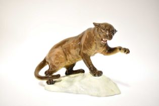 BESWICK; a puma on rocky outcrop, blind stamp number 1702 to the base, height 21cm, and a figure