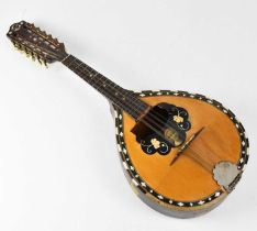 A Marcelli flat back mandolin embossed with jewelled glass, ebony and mother of pearl decoration