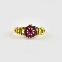 An 18ct gold ring, ruby cluster with three open hoop shoulders, size K, approx. 2.7g.