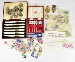 A collectors' lot to include loose stamps, a brass pocket telescope, commemorative spoon, two