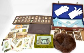 A vintage collectors' lot to include a cigarette card album, various early 20th century postcards, a