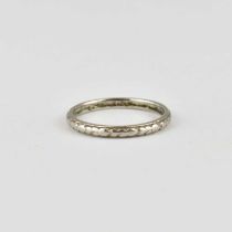 A platinum thin band ring with repeating pattern, size P/Q, approx. 3.5g.