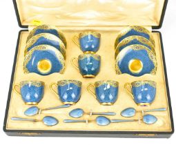 ROYAL WORCESTER; a set of six demitasse coffee cups and saucers with a navy eggshell ground and