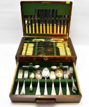 A vintage Art Deco style wooden table-top case containing a 110-piece set of silver plated