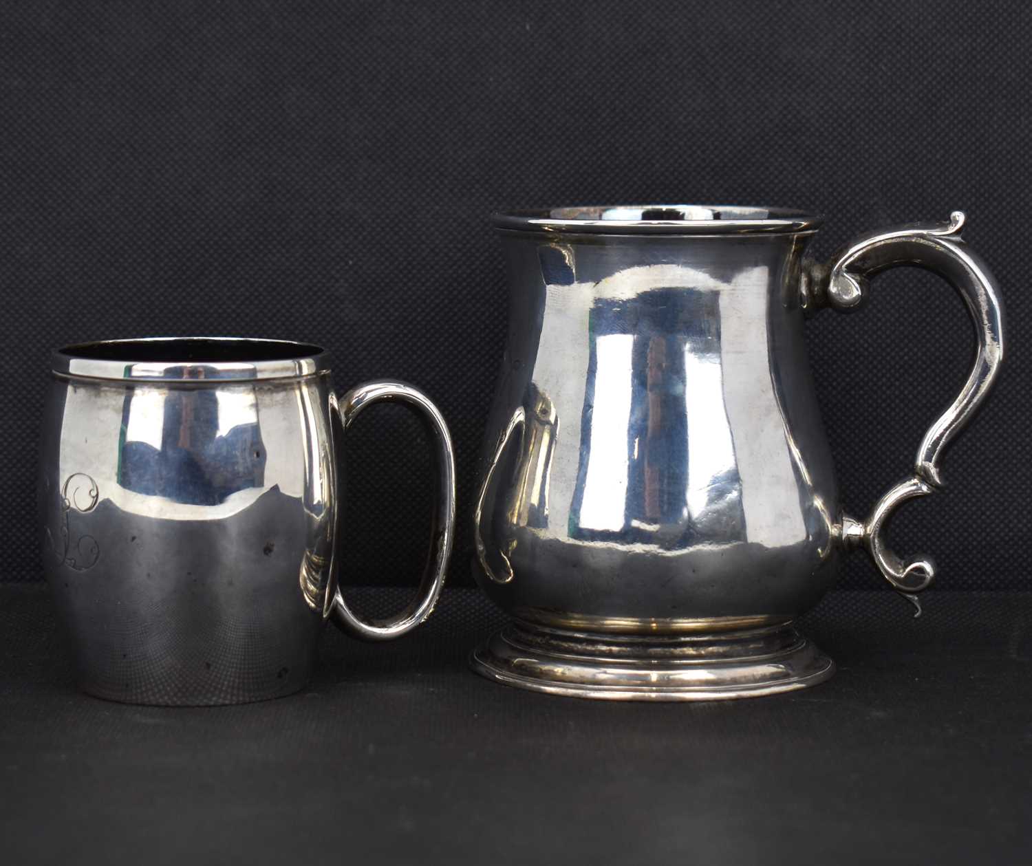 A George III hallmarked silver baluster form mug with ear-shaped handle, initialled 'A' within