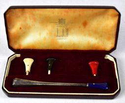 DUNHILL; a hallmarked silver cigarette holder with four coloured interchangeable mouthpieces (one