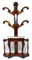 A Victorian mahogany hall stand, with central arched mirror flanked by scrolling coat hooks above