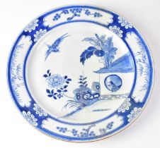 A 19th century Chinese blue and white charger painted with Asiatic pheasants in a pen, within a