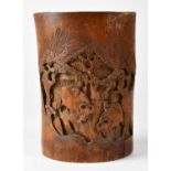 A Japanese bamboo brush pot carved with buffalo within a tree-lined landscape, height 20cm.