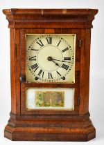 An early 20th century eight-day walnut cased mantel clock, the white enamelled dial set with Roman