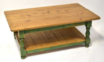 A contemporary stained pine coffee table, with rounded rectangular top above green painted frieze