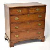 A Georgian oak chest of two short over three long drawers, with brass loop swing handles and