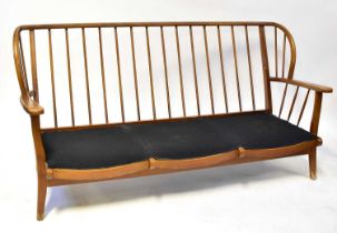 ERCOL; an elm stick back three-seater settee on square tapering legs, 81 x 166cm.
