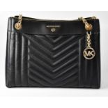 MICHAEL KORS; a 'Susan' quilted shoulder bag in black leather. Condition Report: Good condition used