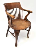 An early 20th century ash and elm open arm bow back chair raised on slender cabriole stretchered