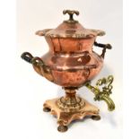 A Victorian copper and brass tea urn.