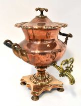 A Victorian copper and brass tea urn.