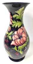 MOORCROFT; a large baluster 'Anemone' pattern vase on a blue ground, with signature for J. Moorcroft