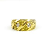 An Egyptian yellow gold ring set with two bezel set white stones, indistinctly marked, size M,