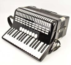 HOHNER; a student seventy-two bass accordion, black and white, in hard carry case.