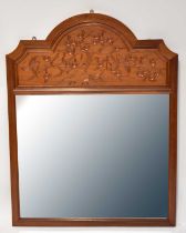 An Oriental-style wall mirror, with rectangular plate beneath arched panel and applied carved