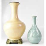 A celadon-style crackle glaze vase of onion form, painted with cranes amongst clouds within a