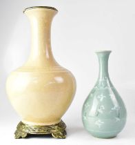 A celadon-style crackle glaze vase of onion form, painted with cranes amongst clouds within a