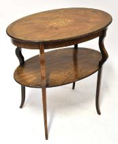 An Edwardian walnut inlaid oval two-tiered occasional table, with shaped tapering supports, 70.5 x