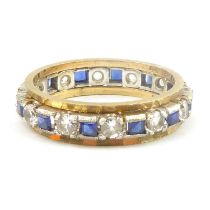 A 9ct gold eternity ring, the central band set with sapphires and white stones in white gold mounts,
