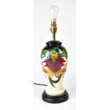 MOORCROFT; an 'Anna Lily' pattern table lamp raised on circular base, height including fitment 39cm.