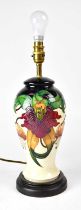 MOORCROFT; an 'Anna Lily' pattern table lamp raised on circular base, height including fitment 39cm.